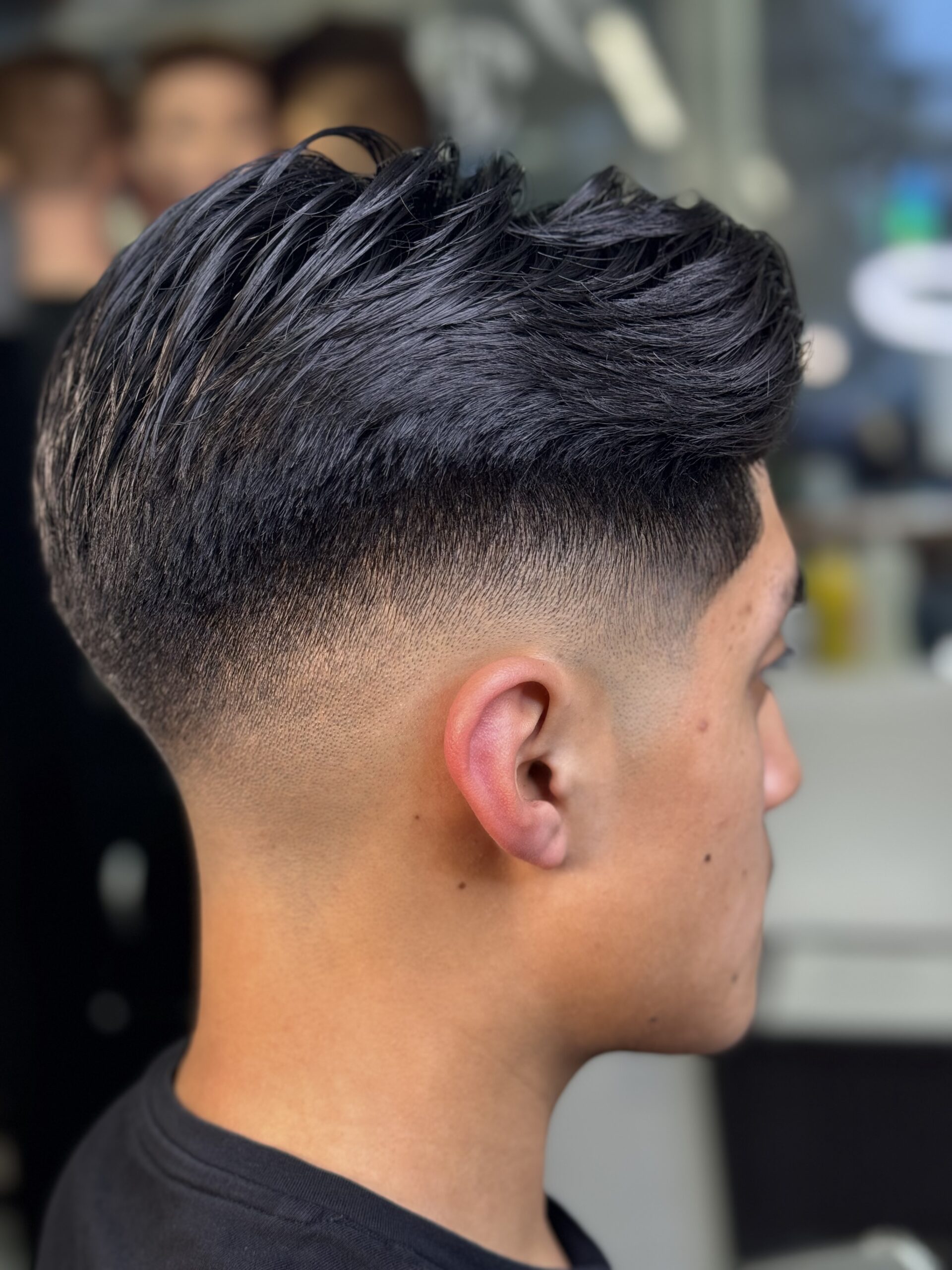 Stylish haircut with faded sides.