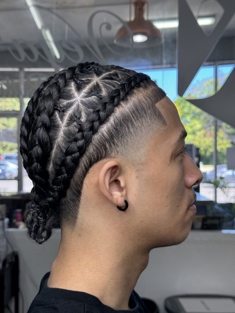 Person with intricate braided hairstyle.