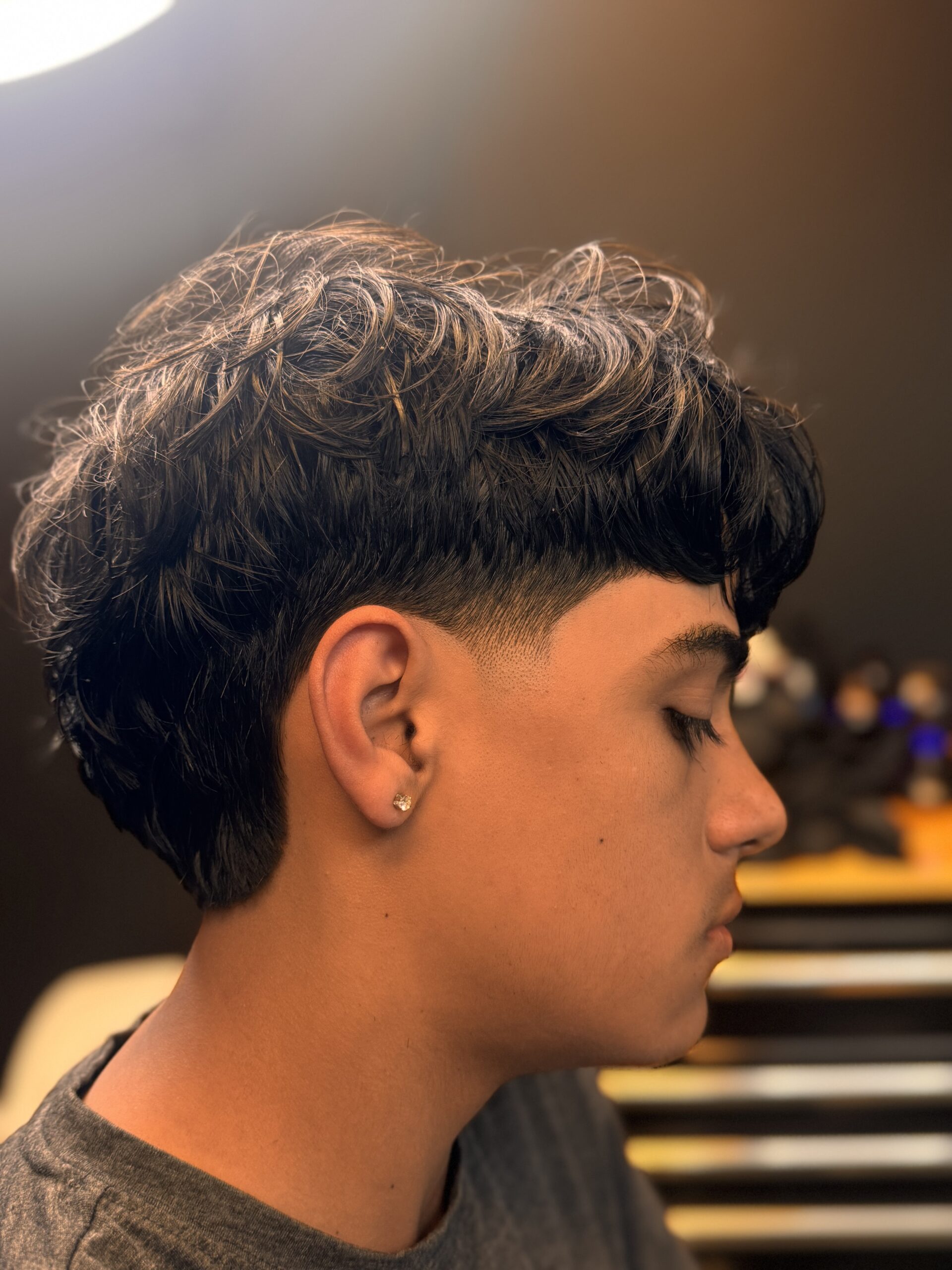 Person with curly hair, side profile.