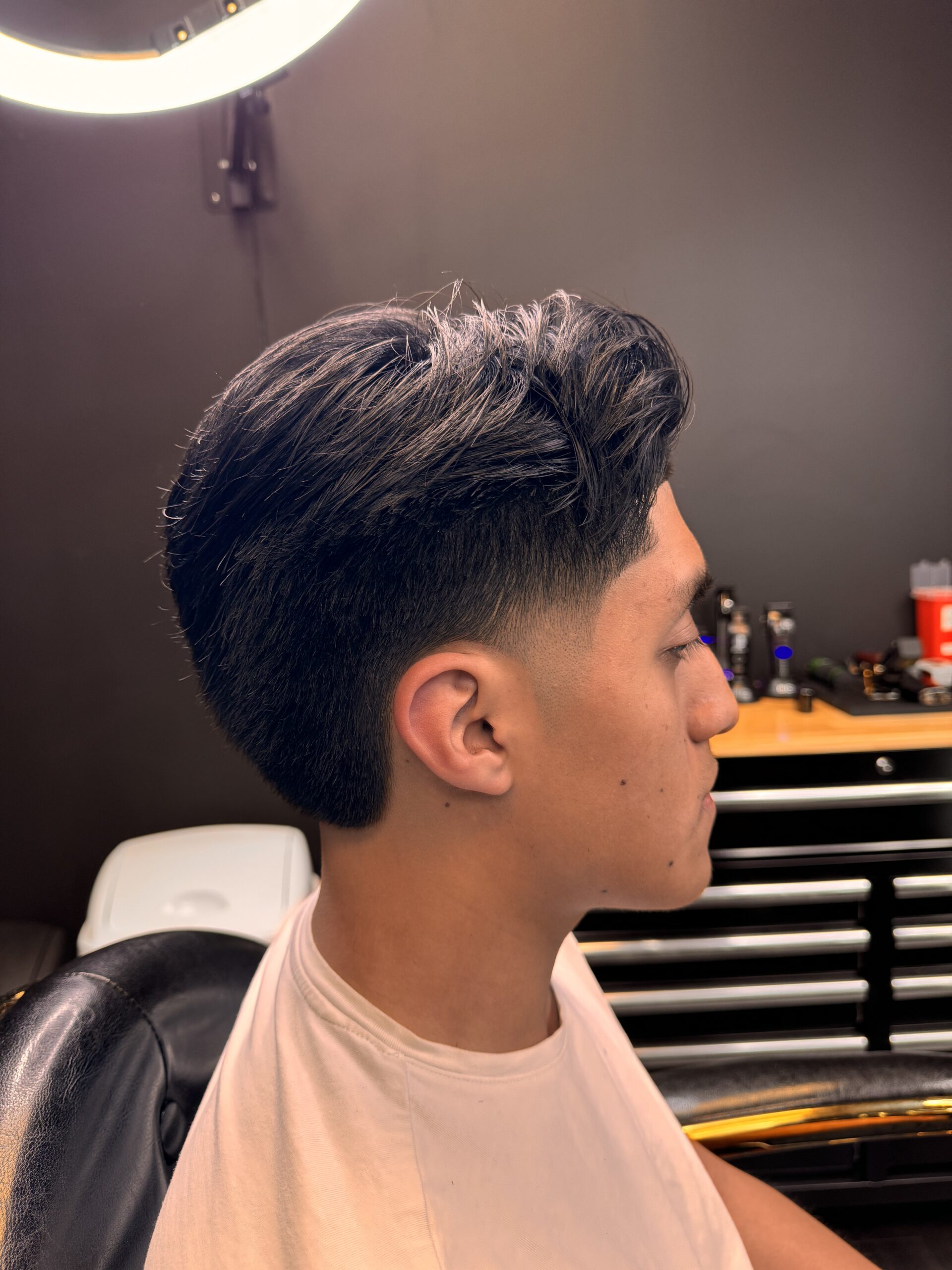 Person with stylish haircut in salon